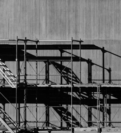 grayscale photography of piled racks